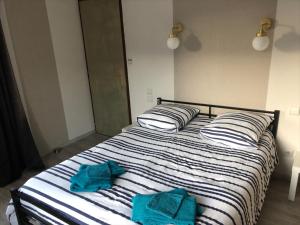 a bedroom with a bed with two towels on it at Appart 8 personnes le calice in Saint-Maurice-sur-Moselle