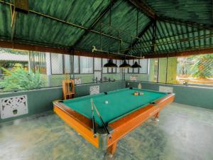 a pool table in the middle of a room at Hotel Blackstone in Hambantota