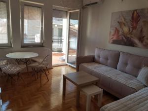 a living room with a couch and a table at Lara apartment in Ohrid