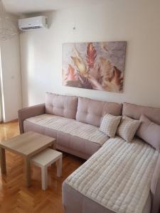 a living room with a couch and a table at Lara apartment in Ohrid