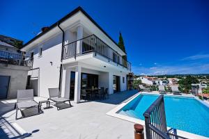 a villa with a swimming pool and a house at Villa Norma in Opatija
