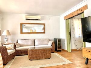 a living room with a couch and a tv at Casa Milana in Moraira
