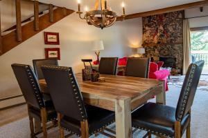 a dining room with a wooden table and chairs at Snowcreek Condo 1579 -Sun Valley Resort Amenities Plus Hot Tub Onsite in Sun Valley