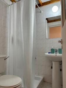 a white bathroom with a toilet and a sink at Villa Saint George - Stone Costa in Kathikas +36 photos