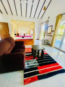 un soggiorno con divano e letto di Maha Oya Lodge a Wayikkal