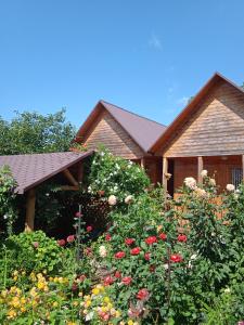 a garden with flowers in front of a house at Abkhazsky Dvorik in Gagra