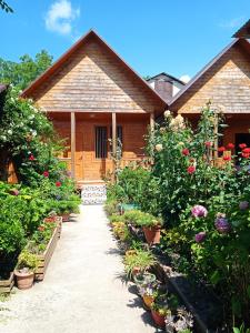 a house with a garden of flowers and plants at Abkhazsky Dvorik in Gagra
