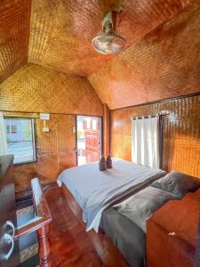 een slaapkamer met een groot bed in een kamer bij Butterfly Hostel, Pai in Pai