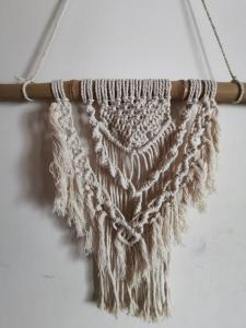 a crochet scarf hanging on a wall at Au bon endroit -- Chambre chez l'habitant -- Via Rhona 