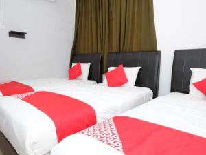 two beds in a room with red and white pillows at Delight Villa-Family Triple 