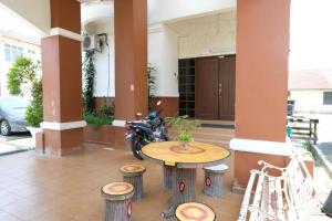 a motorcycle parked next to a table in a building at Delight Villa-Family Triple 