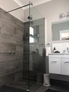 a bathroom with a glass shower and a sink at Number 10 -King bed with breakfast in Stanley