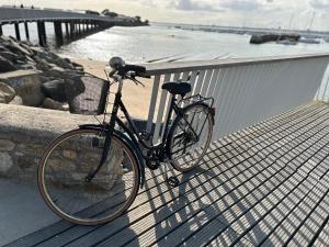 a bike parked on a pier next to the water at Villa en bord de mer in Pornichet