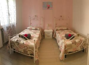 a bedroom with two beds and a dresser in it at Residenza San Michele in Tropea