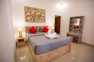 ペニダ島にあるSeven Angels Villa and Hostelのベッドルーム1室(大型ベッド1台、赤い枕付)
