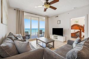 sala de estar con sofá y TV de pantalla plana en Fantastic Private Complex -Beachfront 2BD Ocean Villa! Gorgeous Amenities en Panama City Beach