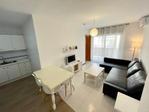 a living room with a couch and a table at La Puntica Carboplaya in Carboneras
