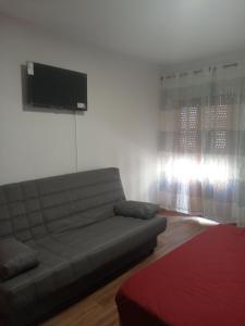 a living room with a couch and a flat screen tv at Cantarranas in Requena