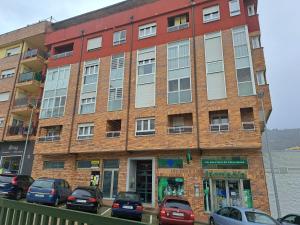 a brick building with cars parked in front of it at El pisito de Irene in Béjar