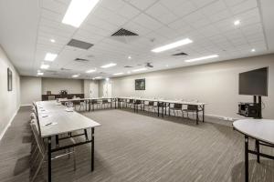 a large room with tables and a flat screen tv at Quest Albury on Townsend in Albury