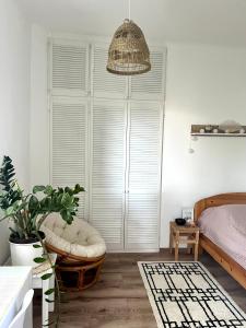 a bedroom with a bed and a large window at Beethoven Apartman in Budapest