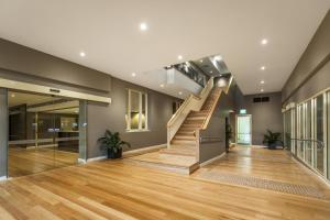 a large stair case in the middle of a room at Quest Albury on Townsend in Albury