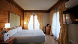 Posteľ alebo postele v izbe v ubytovaní Hotel Grèvol Spa