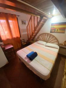 a small bedroom with a bed with a staircase at Casetta Marina Residence in Santa Luria