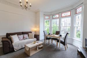 a living room with a couch and a table at April Disc - Long Stay - Contractors in Bristol