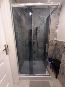 a shower with a glass door in a bathroom at Apartament Tade in Sopot