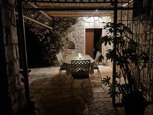 una mesa y sillas con una vela en el patio en TRULLO FERNANDO en San Michele Salentino