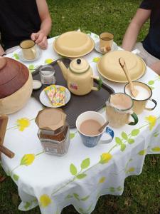 a table with plates and pots and pans on it at Ledoba Bed & Breakfast 