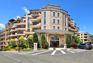 a large building with a parking lot in front of it at Premium 2 bedroom flat at Millennium 2 in Sveti Vlas