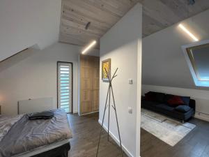 an attic bedroom with a bed and a couch at Appena Guest House 2 in Krakow