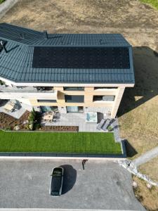 an overhead view of a house with solar panels on the roof at 4Monkeys Apartments in Balderschwang