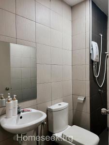 a bathroom with a toilet and a sink at Homeseek, Spacious and Cozy Apartment in Kuala Terengganu in Kuala Terengganu