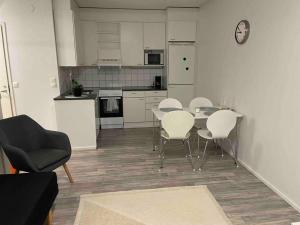 a kitchen with a table and chairs in a room at CheapRooms in Tornio city in Tornio