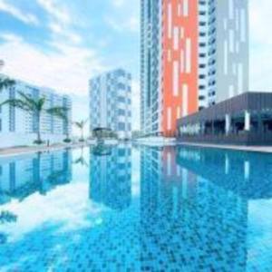 a large swimming pool in a city with tall buildings at JOVIAL Modern Cozy Homestay `Meritus Perai in Perai