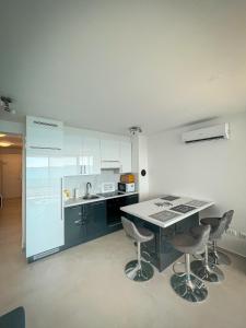 a kitchen with a table and chairs in a room at Apartman Lana&Bruno in Mandre