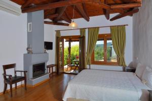 a bedroom with a bed and a fireplace at Alkifron Hotel in Kala Nera
