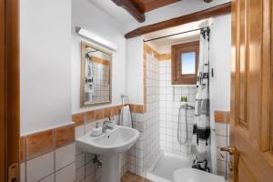 a white bathroom with a sink and a shower at Alkifron Hotel in Kala Nera