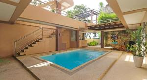 a swimming pool in the middle of a house at Villa Tomasa Beach Resort Panglao in Panglao Island