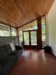 a living room with a couch and some windows at Olosiva Oasis in Arusha