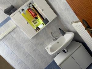 a bathroom with a white sink and a mirror at my Green Villa in Zakharo