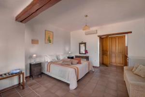 a bedroom with a bed and a couch at Alkifron Hotel in Kala Nera