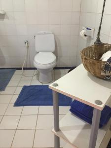 a bathroom with a toilet and a basket on a table at Sang Tong Huts in Mae Hong Son