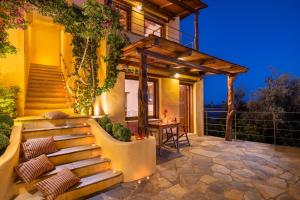 a patio with stairs leading up to a house at Alkifron Hotel in Kala Nera