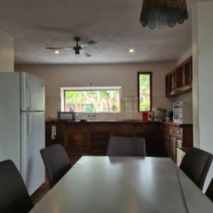 a kitchen with a table and chairs and a refrigerator at Olosiva Oasis in Arusha