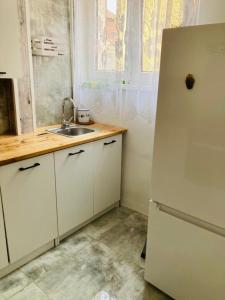 a kitchen with a white refrigerator and a sink at Apartamenty Every Sky Plac Ratuszowy 30 in Jelenia Góra