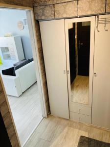 a room with a sliding door and a couch at Apartamenty Every Sky Plac Ratuszowy 30 in Jelenia Góra